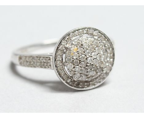 A 9CT WHITE GOLD DIAMOND CLUSTER RING.