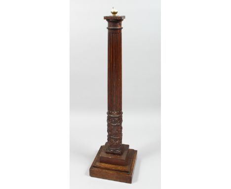 A CARVED AND FLUTED OAK COLUMN on a lamp base.