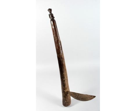 A TRIBAL AXE with metal blade.  23ins long.