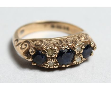 A VICTORIAN 9CT GOLD SAPPHIRE THREE STONE RING.