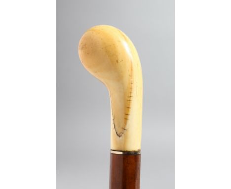 A WALKING STICK WITH CARVED IVORY HANDLE.