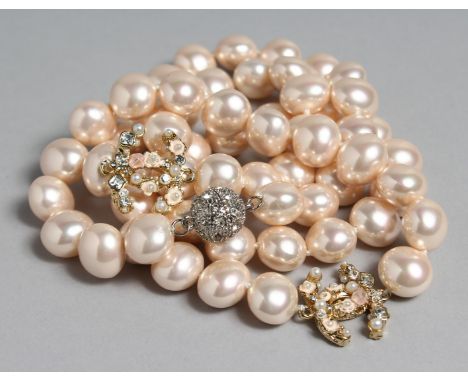 A GOOD CHANEL LONG LARGE PEARL NECKLACE with two intwined enamel 'C's'.