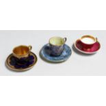 A WEDGWOOD LUSTRE MINIATURE CUP AND SAUCER WITH GILT DECORATION, A COALPORT BLUE AND RAISED GILT CUP