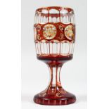 A GOOD BOHEMIAN GOBLET with a ruby overlay and six etched circles of flowers. 6.5ins high.
