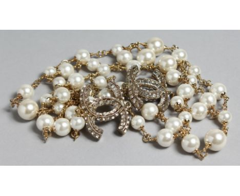 A GOOD CHANEL LONG LARGE PEARL NECKLACE with two entwined brilliant  'C's'.