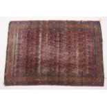 AN EARLY 20TH CENTURY PERSIAN RUG, red ground with all overt design of stylized Botek. 6ft 10ins x