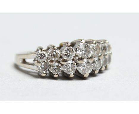 A 14CT WHITE GOLD TWO ROW DIAMOND RING.