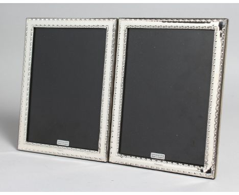 A PAIR OF SILVER AND ENAMEL PHOTOGRAPH FRAMES. 8ins x 6ins.