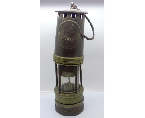 An Ackroyd &amp; Best miner's safety lamp 