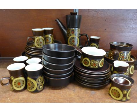 A Denby Arabesque dinner and coffee service including six side plates, six plates, seven mugs and saucers, a salt and pepper 
