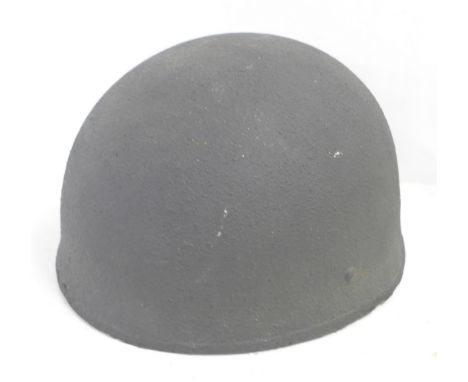 A WWII Army helmet, the inner head piece marked BMB 1942 7¼ 
