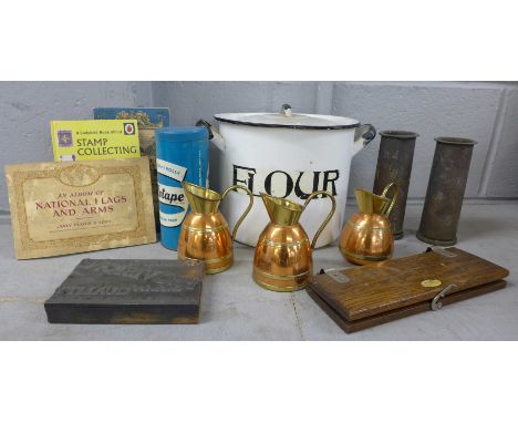 An enamel 'flour' container, Sellotape tin, a pair of trench art shell cases, three small copper jugs, a printing block, tie 