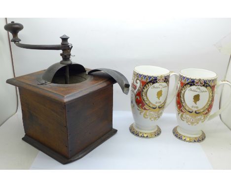 A coffee grinder and two Queen Elizabeth II Golden Jubilee mugs 