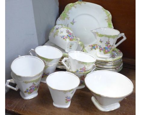 A Standard China tea service, nine cups and saucers, twelve side plates, sugar, cream and a cake plate 