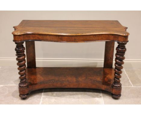 A mid-19th century walnut console table, the serpentine top upon substantial barley twist supports, united by a concave under