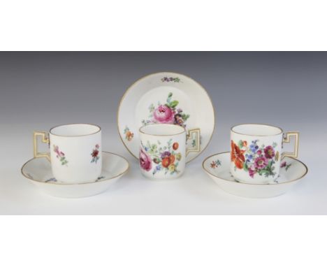Three Meissen Marcolini period cups and saucers, circa 1810, each finely enamelled with bouquets of flowering blooms within g
