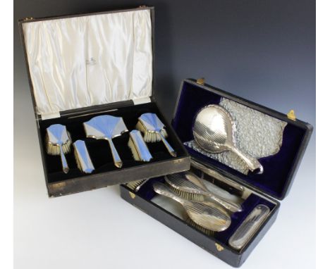 An Art Deco silver and enamel backed dressing table set, A & J Zimmerman Ltd, 1930-31, comprising; a hand mirror and four bru