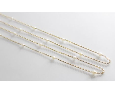 A yellow metal guard chain, the cable link chain interspersed with 22 round cultured pearl spacers, spring ring and loop fast