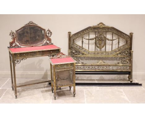 A French Belle Epoque brass three piece bedroom suite, comprising; a dressing table with a shaped mirror raised upon supports