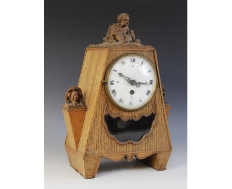 A Bavarian oak cased carved mantel clock, early 20th century, of pyramidal form surmounted with cherubs, the 13cm enamelled w