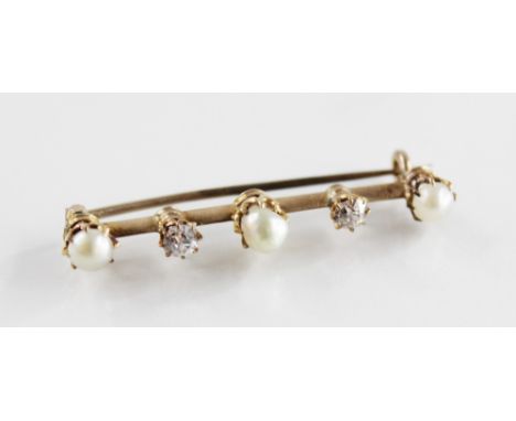 An early 20th century diamond and pearl set bar brooch, comprising a central baroque pearl with an old cut diamond to each si
