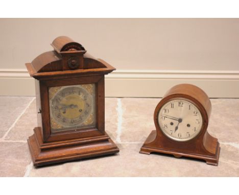 An early 20th century oak cased bracket clock, the architectural case enclosing the 15cm gilt metal and silvered square dial,