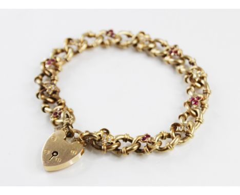 A Victorian gold coloured diamond and ruby set bracelet, the curb-link bracelet with applied leaf motifs set with rose cut di