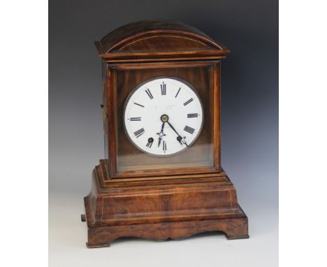 A mid 19th century walnut cased German bracket clock retailed by Camerer Kuss & Co, London, the arched pediment above a hinge