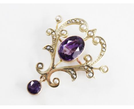 An Edwardian amethyst and seed pearl set brooch/pendant, comprising a central mixed cut amethyst measuring 10mm x 8mm, set to