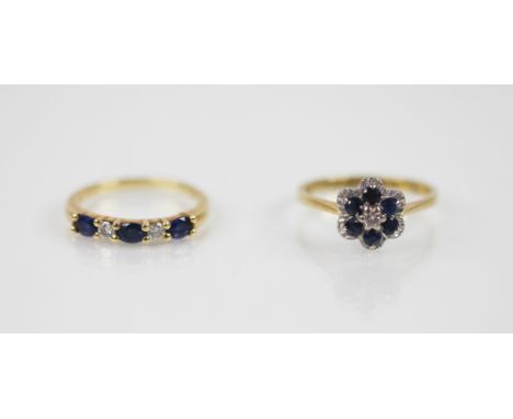 A diamond and sapphire five stone 18ct gold ring, comprising three oval mixed cut sapphires and two round brilliant cut diamo