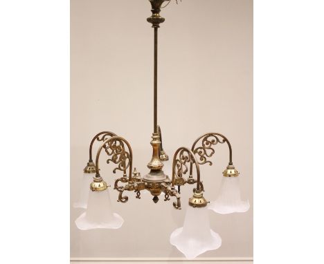 An early 20th century brass chandelier, the plain cylindrical support extending to a baluster shaped pendant over five arched