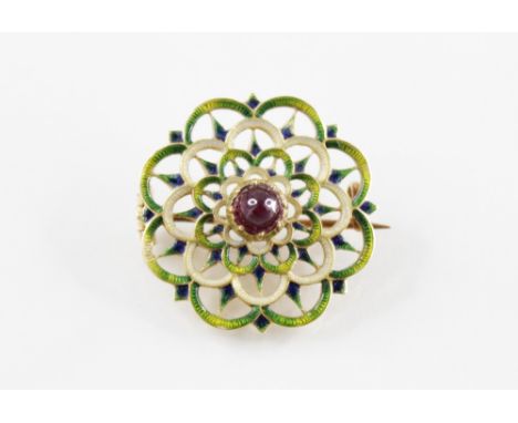 An late 19th century enamel and garnet set target brooch by Carlo & Arthur Giuliano, the central garnet cabochon measuring ap