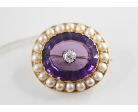 An early 20th century diamond, amethyst and pearl set target brooch, the central old mine cut diamond measuring 4.37mm x 4.19