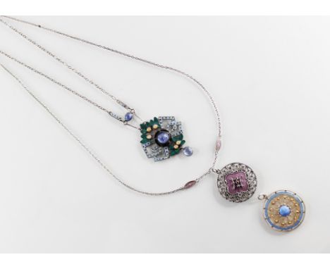 An Arts & Crafts style necklace, the pierced silver coloured pendant frame set with three blue gemstone cabochons, decorated 