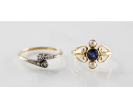 An early 20th century diamond set ring, comprising two round single cut diamonds collet set to cross-over diamond set shoulde