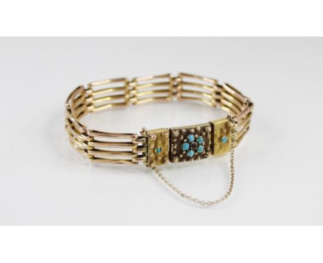 A Victorian bracelet, the rectangular clasp set with a turquoise and ruby floral cluster and and applied decoration, set to a