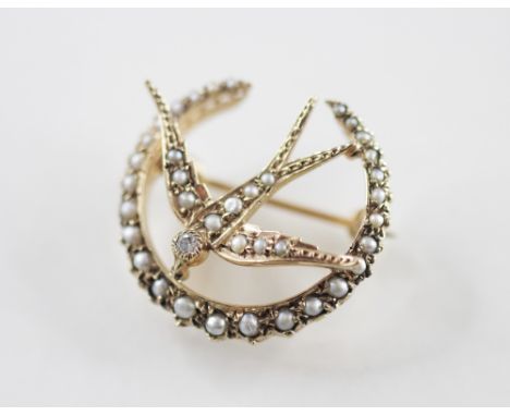A Victorian style pearl and diamond 9ct gold swallow brooch, the swallow with a brilliant cut diamond set to head an half pea