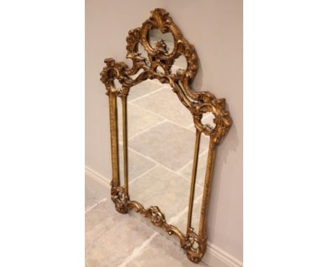 A Louis XVI style gilt composite wall mirror, late 20th century, the rococo style frame with a 'C' scroll moulded crest and s