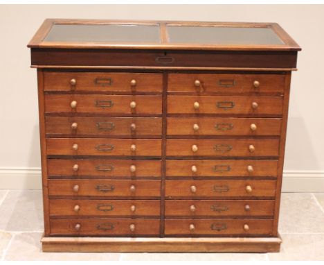 A Victorian mahogany haberdasher's cabinet, the removable upper table top display with sloping hinged door, upon a chest with