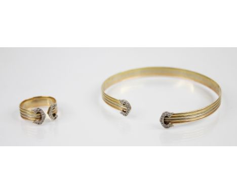 An 18ct gold diamond set torque bangle, the three-colour 18ct gold bangle of reeded form with diamond set terminals, 6.3cm x 