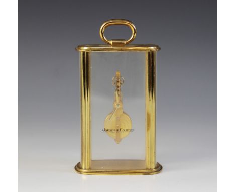A Jaeger-Le Coultre mystery timepiece, the lacquered brass case with glazed convex front and side panels, enclosing the in li