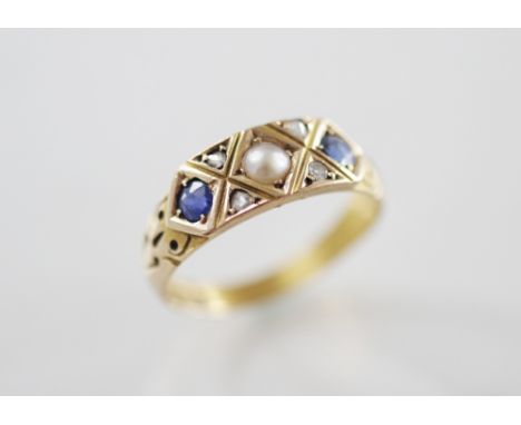 A Victorian pearl, sapphire and diamond set 15ct gold ring, comprising a central half-pearl flanked by two old cut sapphires,