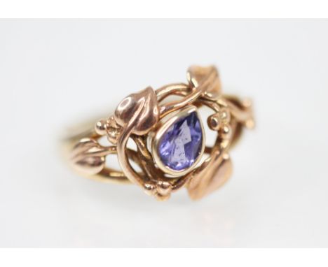 A 14ct Clogau gold tanzanite set ring, the central mixed pear cut tanzanite measuring 6mm x 4mm, set to a scrolling foliate r