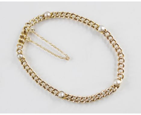 An Edwardian yellow metal pearl set bracelet, the curb link chain set with five cultured half pearls, tongue and box snap cla