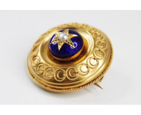 A Victorian pearl and enamel Etruscan style target brooch, the central carbuncle comprising a half-pearl set to a starburst s