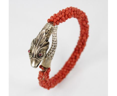 A Victorian coral snake bracelet, the head and tail with scale effect decoration, red pastes set to eyes, the body decorated 