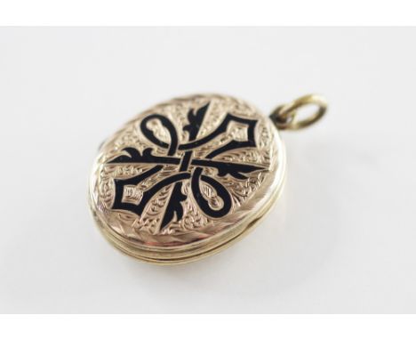 A Victorian mourning locket pendant, the oval shaped pendant with black enamel detailing and engraved decoration, two vacant 