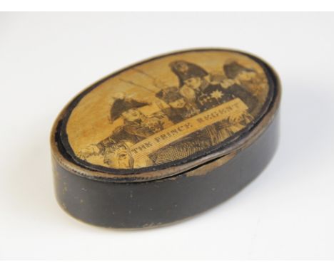 An early 19th century ebonised snuff box, of oval form with hinged cover, the cover decorated with the Prince Regent amongst 