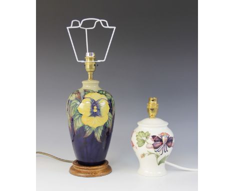 A Moorcroft table lamp, of tapering high shouldered form, decorated in a yellows pansies pattern on a cobalt vase, on turned 