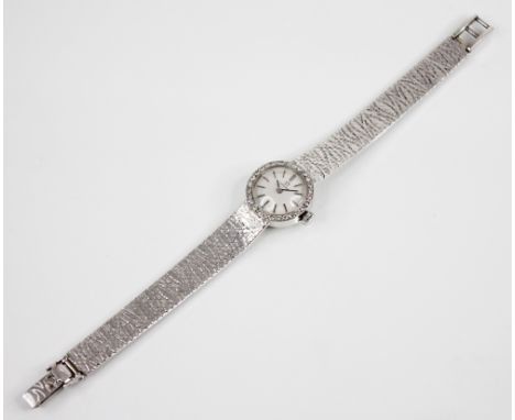 An 18ct gold diamond set Omega cocktail watch, the circular silvered dial with baton markers, set to a plain polished 18ct wh